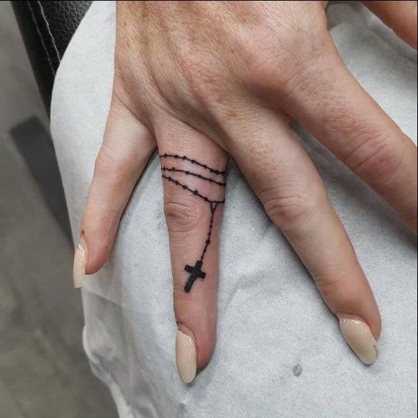 cross tattoos on finger with chain