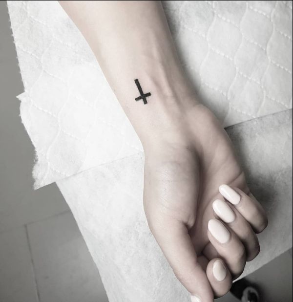 tiny cross tattoo on wrist
