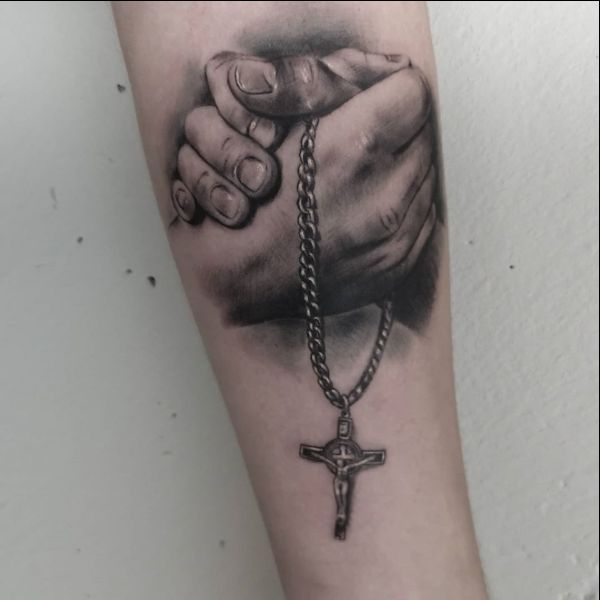 cross tattoos on holding hand