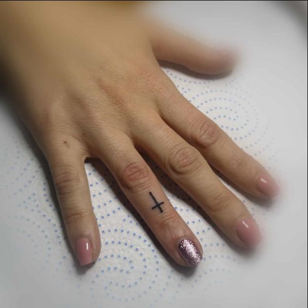 tiny cross tattoos on finger