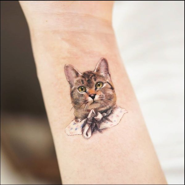 small cat picture tattoo on wrist