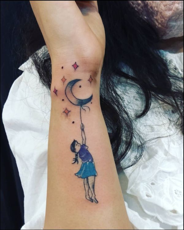 small moon tattoo on wrist