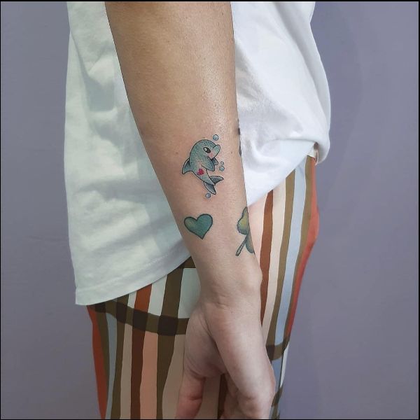 dolphin tattoos on the arm