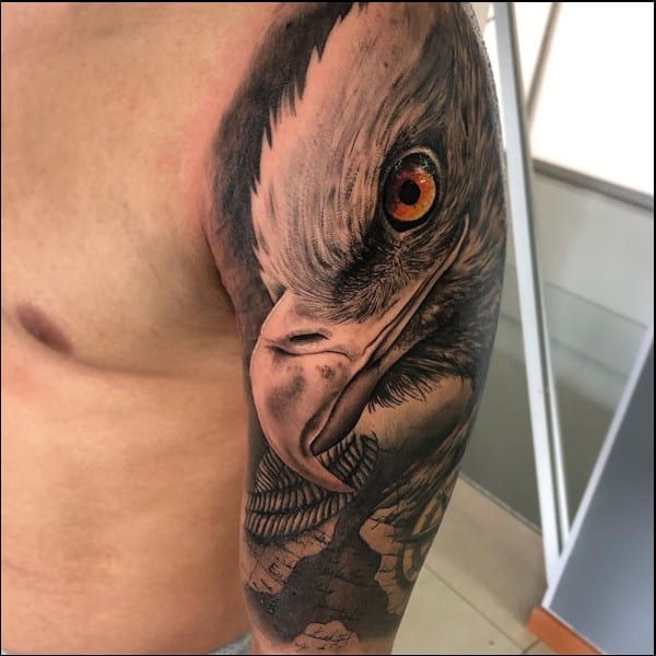 Eagle face tattoo on arm