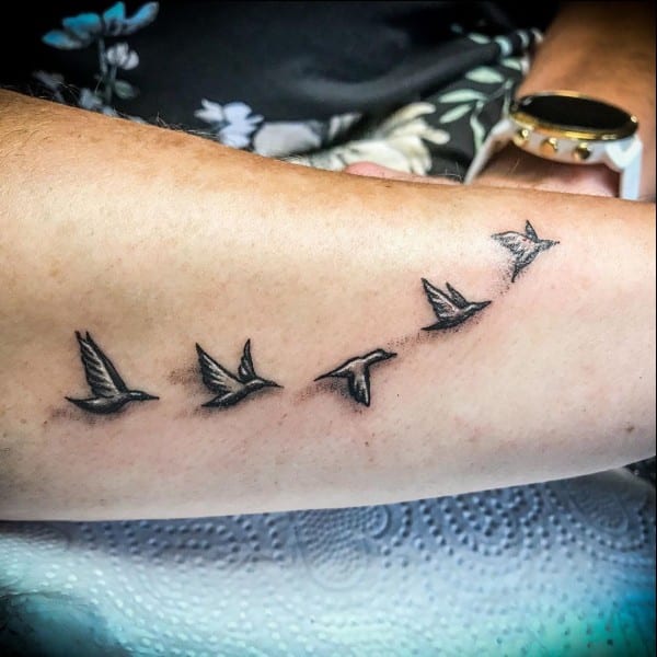 flying away bird tattoos