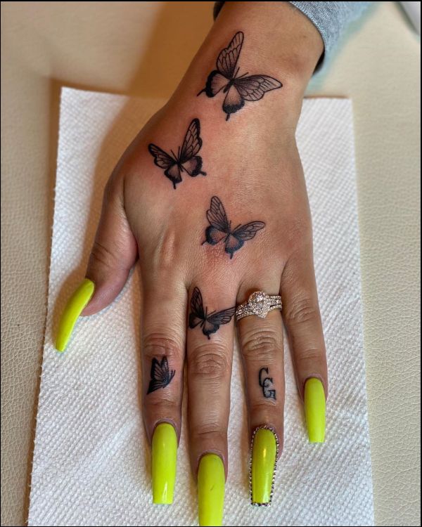 small butterflies hand tattoos