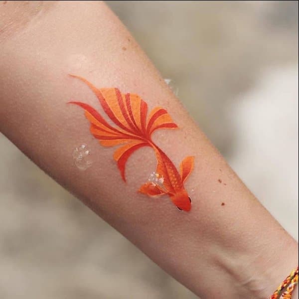 small koi fish tattoo on forearm