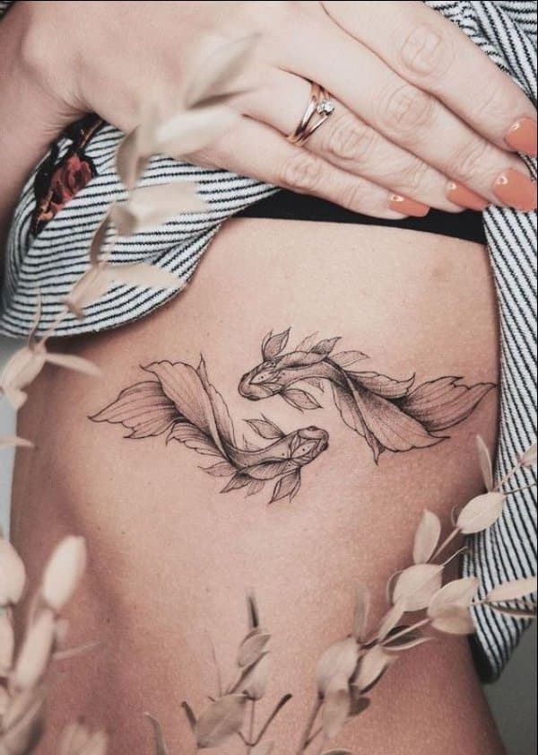 two koi fish tattoo on ribs
