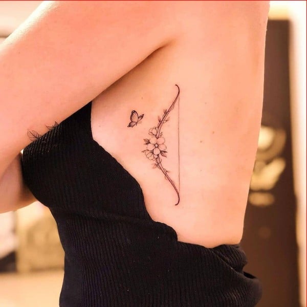 bow tattoos ribcage for women